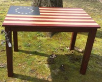 Wooden table painted with American flag on top and black legs