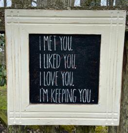 Black sign, framed in white that says "I met you, I liked you, I love you, I'm keeping you"