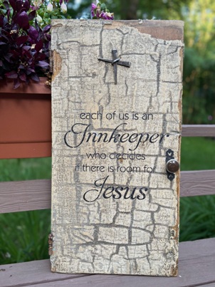 Distressed wooden sign with Home stenciled on it.