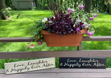 wooden signs that say Love, Laughter, Happily Ever After