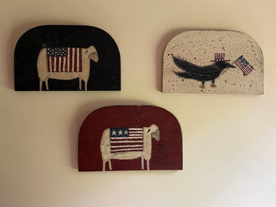 Hand painted signs. Two with sheep and one with a crow done in Americana style.