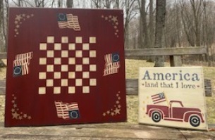 Wooden stenciled flag checkerboard and America stenciled sign