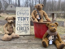 Three primitive bears and a wooden stenciled sign that says Our Family is just one tent away from a full blown circus