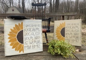 Two wooden sunflower signs