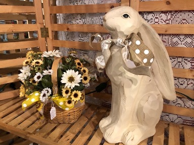 Tall resin bunny with bow and basket of white and yellow flowers